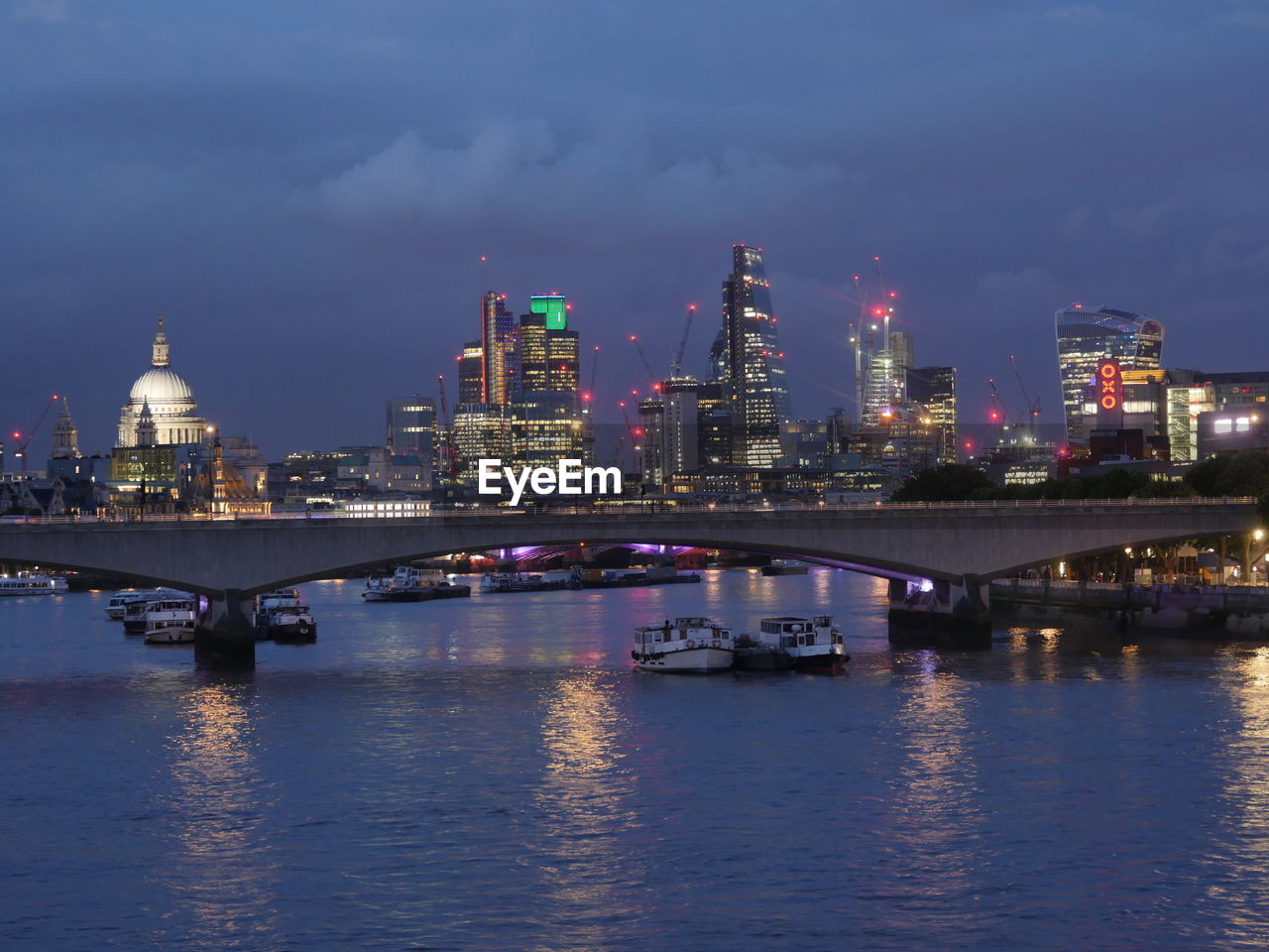 Illuminated city at waterfront