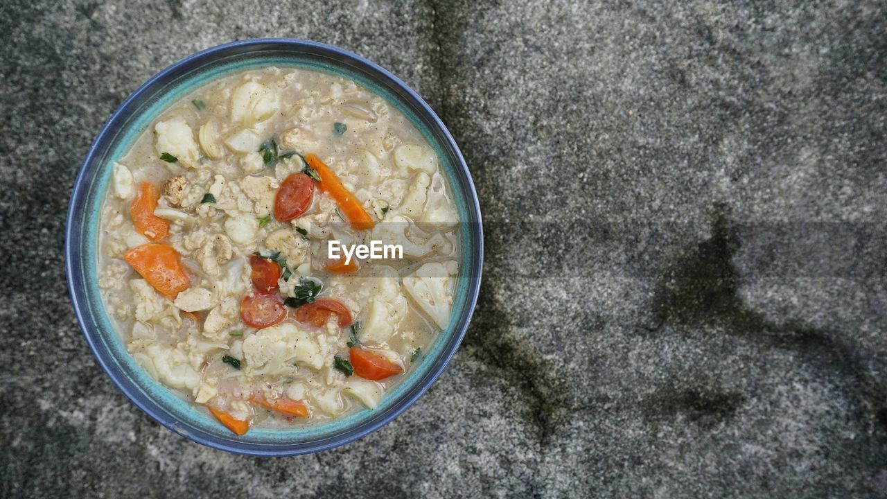 DIRECTLY ABOVE SHOT OF SOUP IN BOWL AGAINST WHITE BACKGROUND