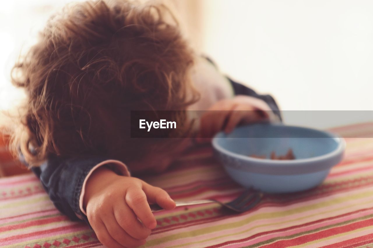 Close-up of relaxed boy at dining table