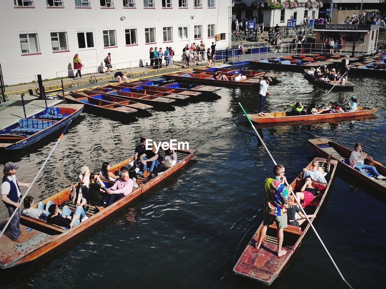 HIGH ANGLE VIEW OF PEOPLE ON BOAT IN CANAL