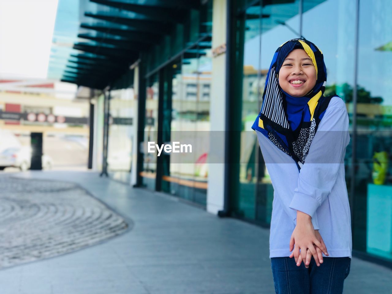 Girl wearing hijab while standing in city