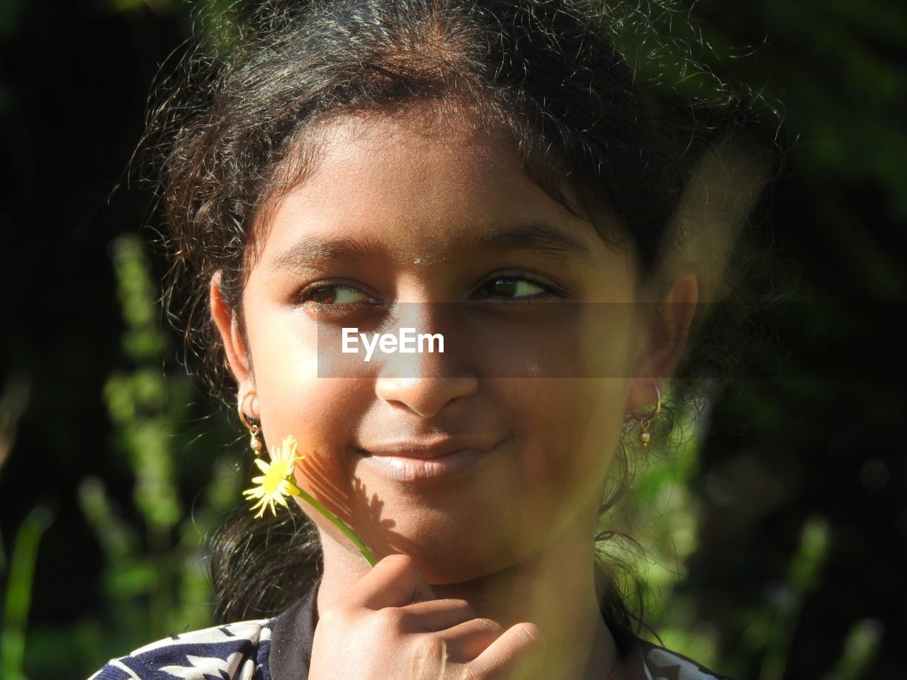 Close-up of smiling girl looking away