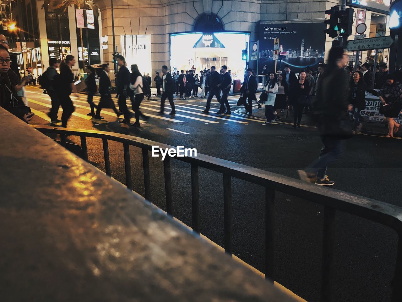 CROWD WALKING ON STREET IN CITY