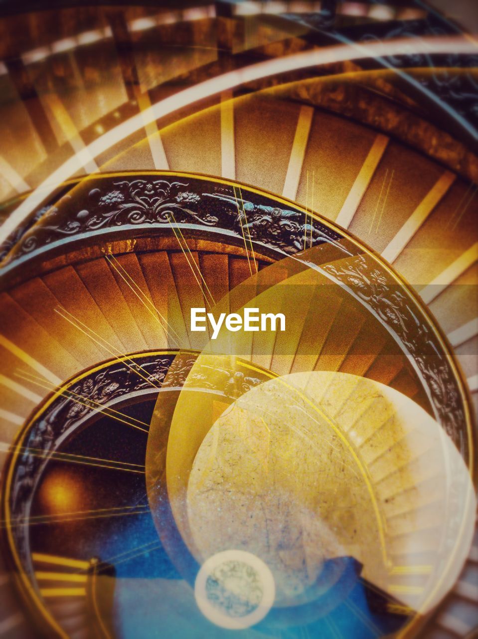 HIGH ANGLE VIEW OF SPIRAL STAIRCASE IN SUNLIGHT