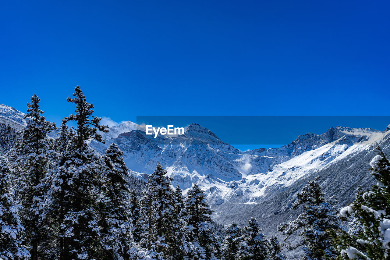 panoramic view of snowcapped mountains against clear blue sky