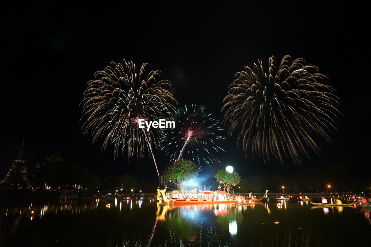 fireworks, night, firework display, celebration, illuminated, event, arts culture and entertainment, exploding, motion, reflection, water, firework - man made object, new year's eve, recreation, sky, nature, no people, architecture, outdoors, multi colored, city, glowing, dark, travel destinations