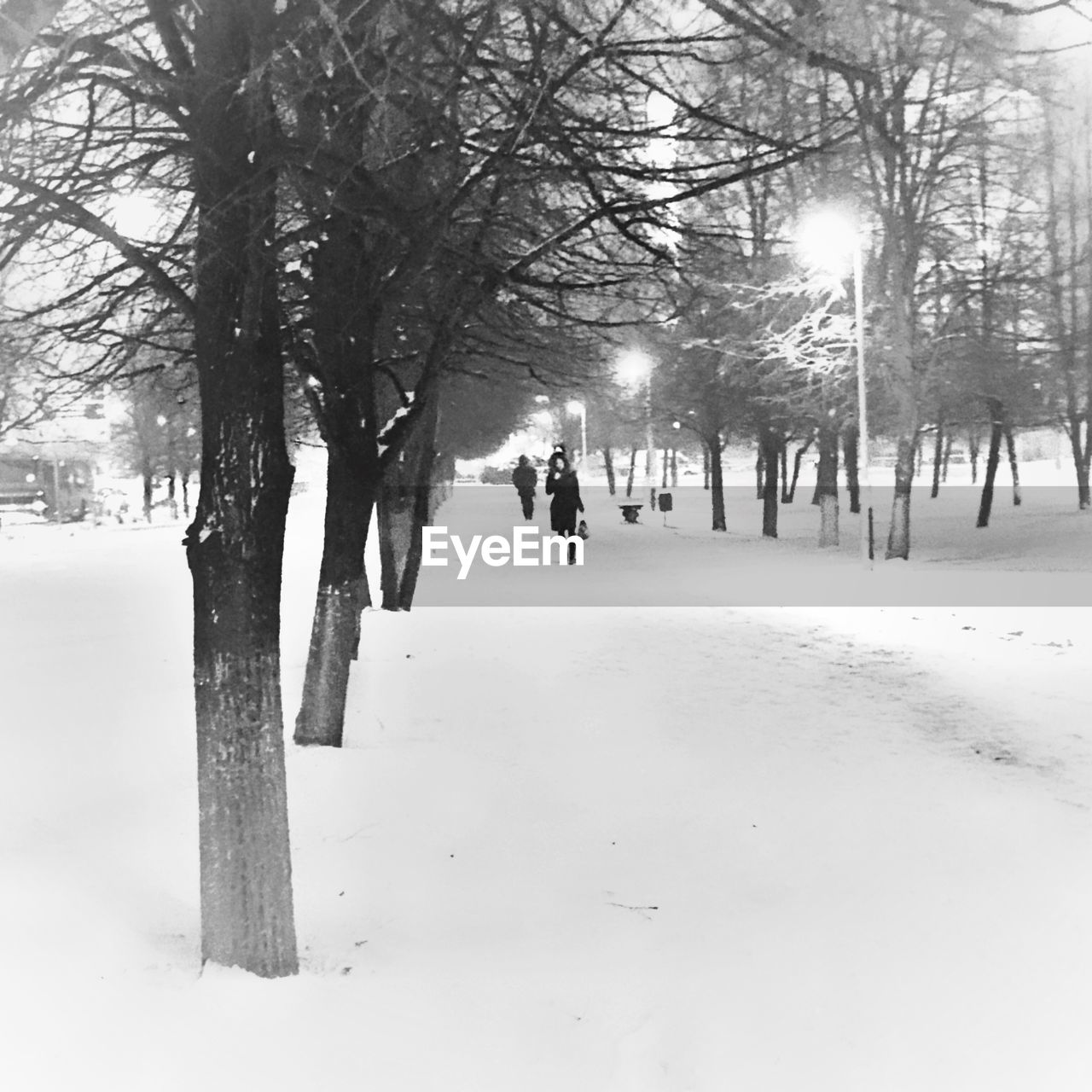 MAN WALKING ON SNOW COVERED STREET