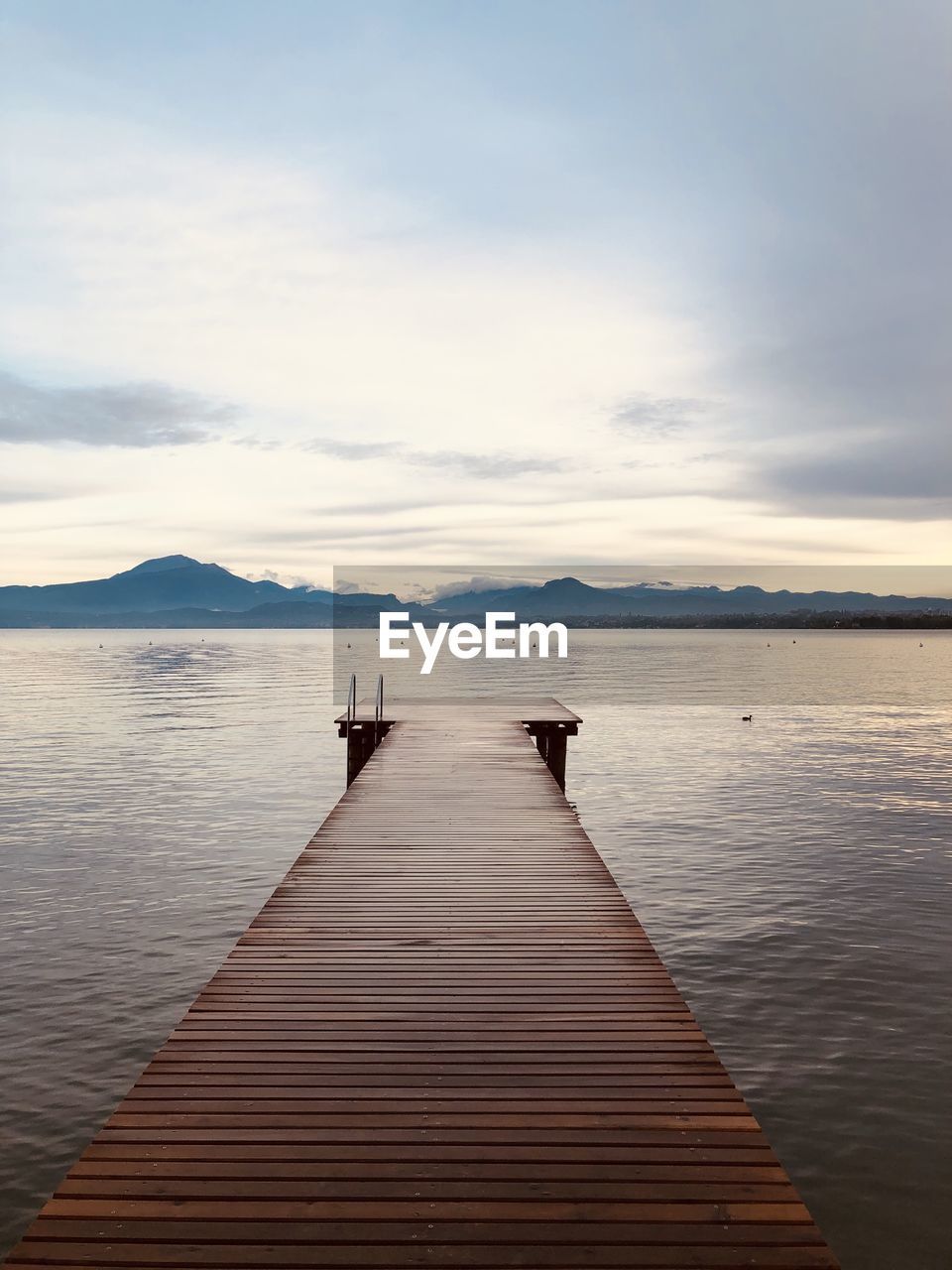 Pier over lake against sky