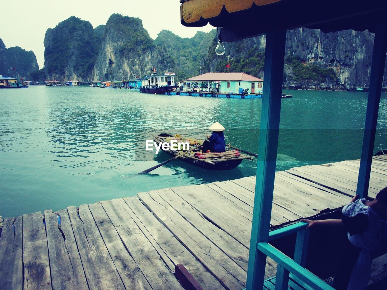 Rear view of female vendor at floating market
