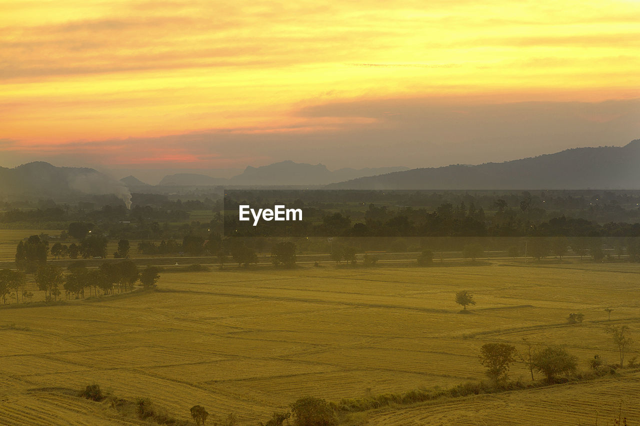 Scenic view of field against sky during sunset