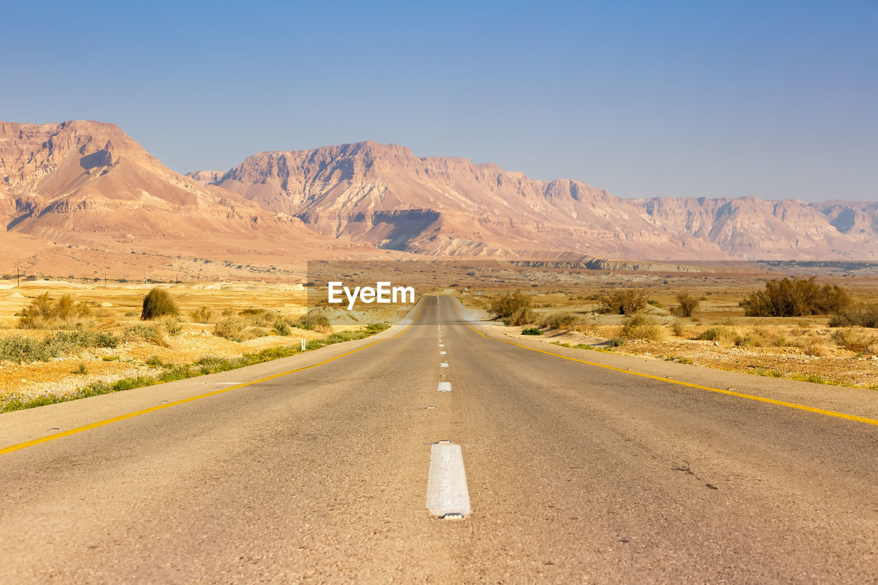 VIEW OF ROAD PASSING THROUGH DESERT