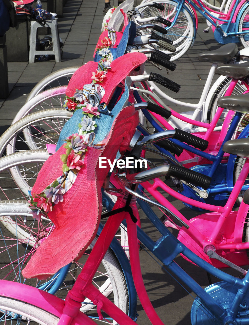 HIGH ANGLE VIEW OF BICYCLES PARKED IN PARKING LOT