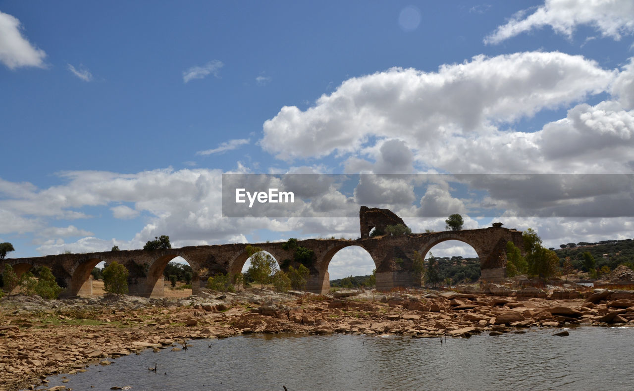 cloud, sky, architecture, bridge, water, built structure, nature, sea, no people, coast, arch, environment, landscape, transportation, rural area, day, shore, travel destinations, outdoors, blue, travel, land, scenics - nature, history