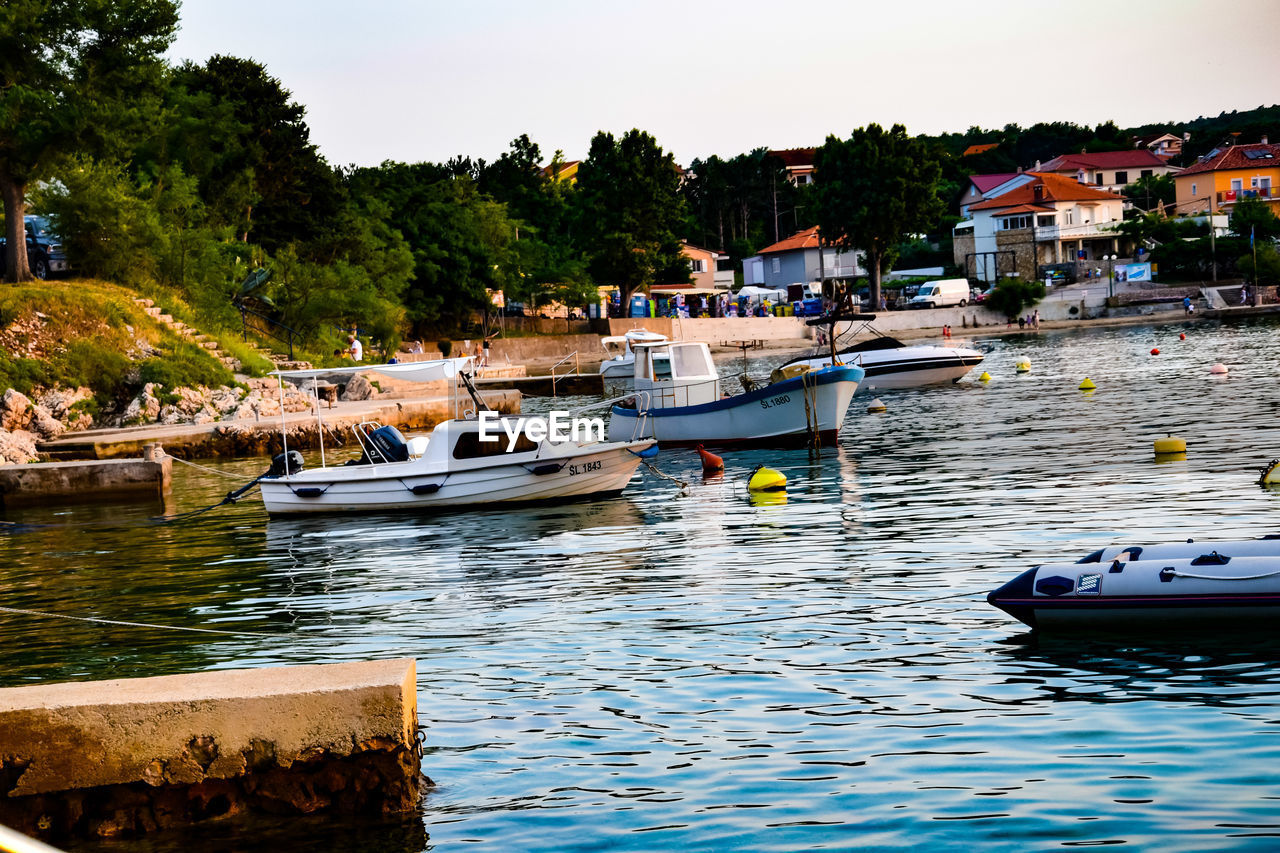 BOATS MOORED AT RIVERBANK