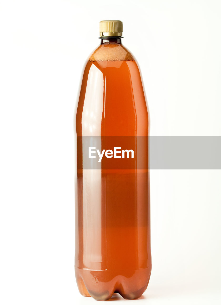 Close-up of liquid in bottle against white background