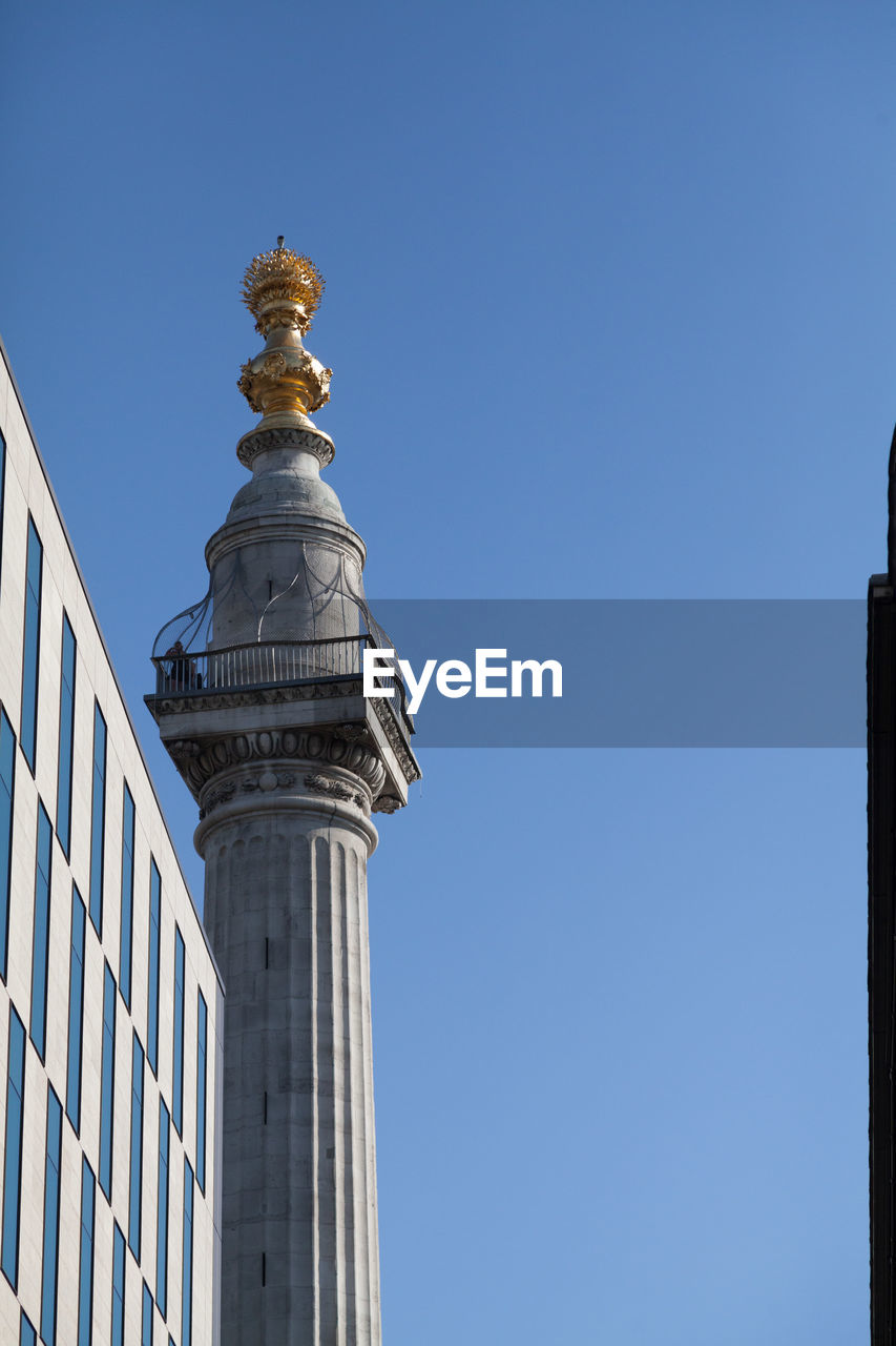 LOW ANGLE VIEW OF BUILT STRUCTURE AGAINST BLUE SKY