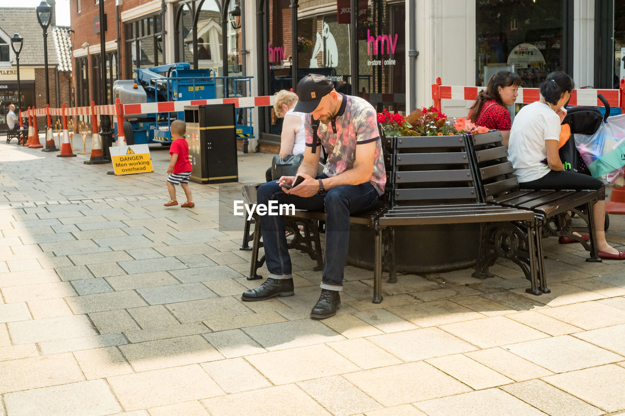 PEOPLE SITTING IN SHOPPING MALL