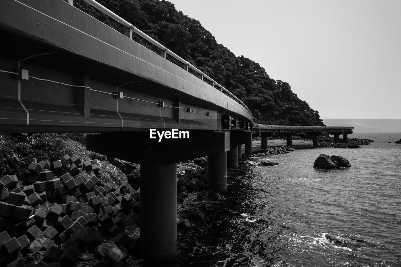 Overpass by sea against sky