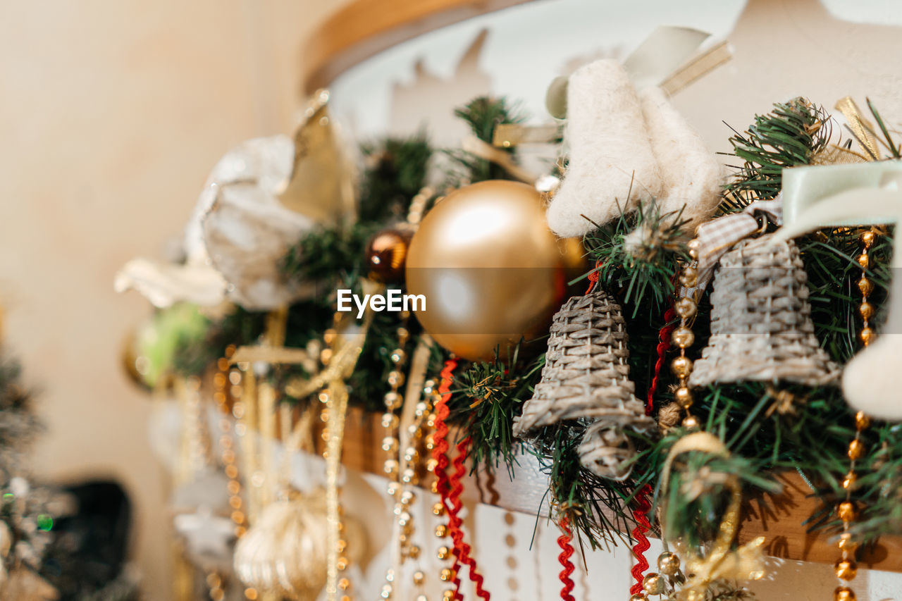 Beautiful holdiay decorated fireplace with baubles, felt boots.