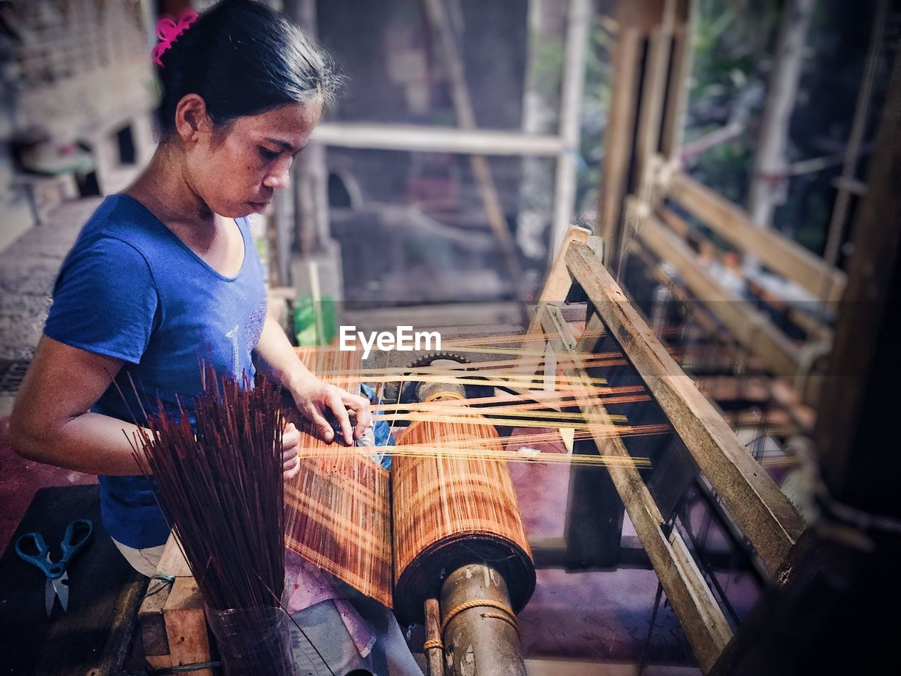Woman weaving loom