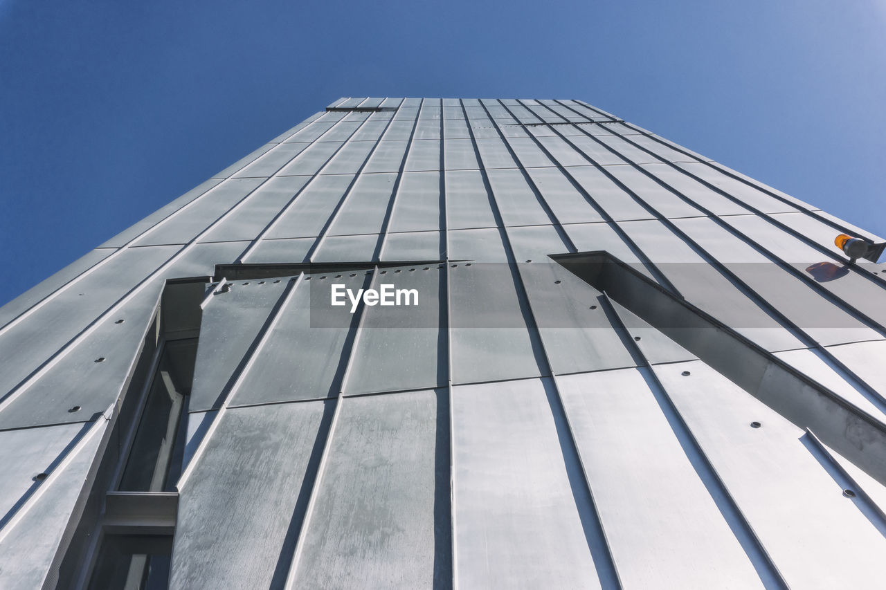 Low angle view of building against clear blue sky during sunny day