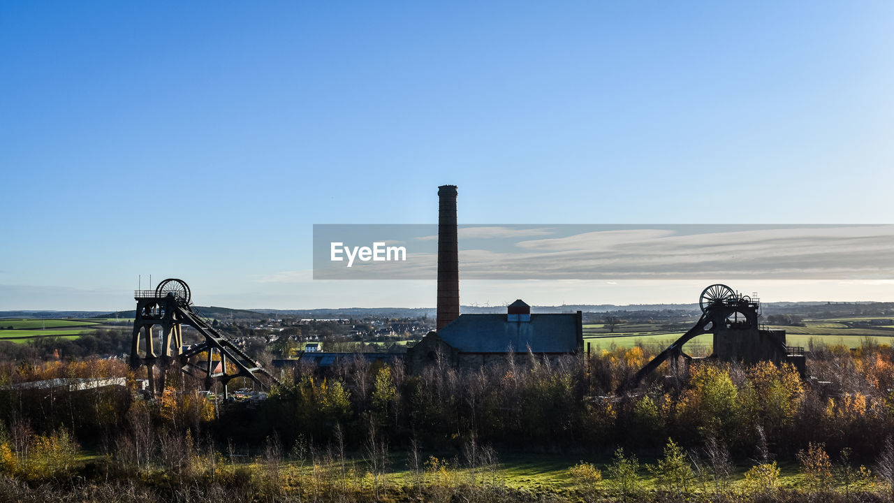 sky, nature, blue, landscape, horizon, clear sky, plant, no people, architecture, rural area, grass, environment, land, day, copy space, built structure, scenics - nature, transport, field, outdoors, water, sunlight, hill, transportation, sunny, cloud, tranquility, rural scene, coast, beauty in nature