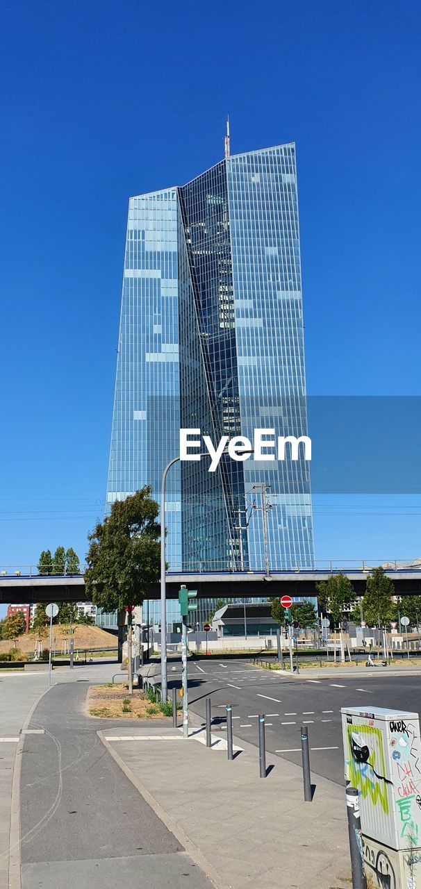 architecture, built structure, sky, skyscraper, building exterior, tower block, blue, city, clear sky, nature, day, building, facade, outdoors, no people, urban area, communication, landmark, sunlight, office building exterior, technology, sunny, business, low angle view