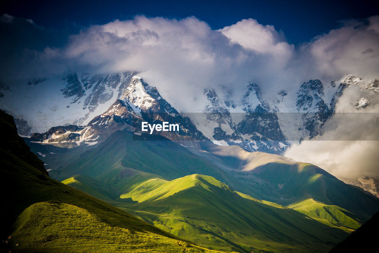 Panoramic view of snowcapped mountains against sky