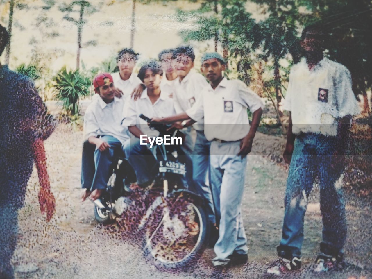 group of people, men, adult, transportation, full length, day, vehicle, togetherness, women, casual clothing, land vehicle, mode of transportation, nature, leisure activity, young adult, tree, group, friendship, lifestyles, outdoors, female, tire, person, medium group of people, emotion, clothing, smiling, happiness, wheel, sitting, fun, standing, bicycle, plant