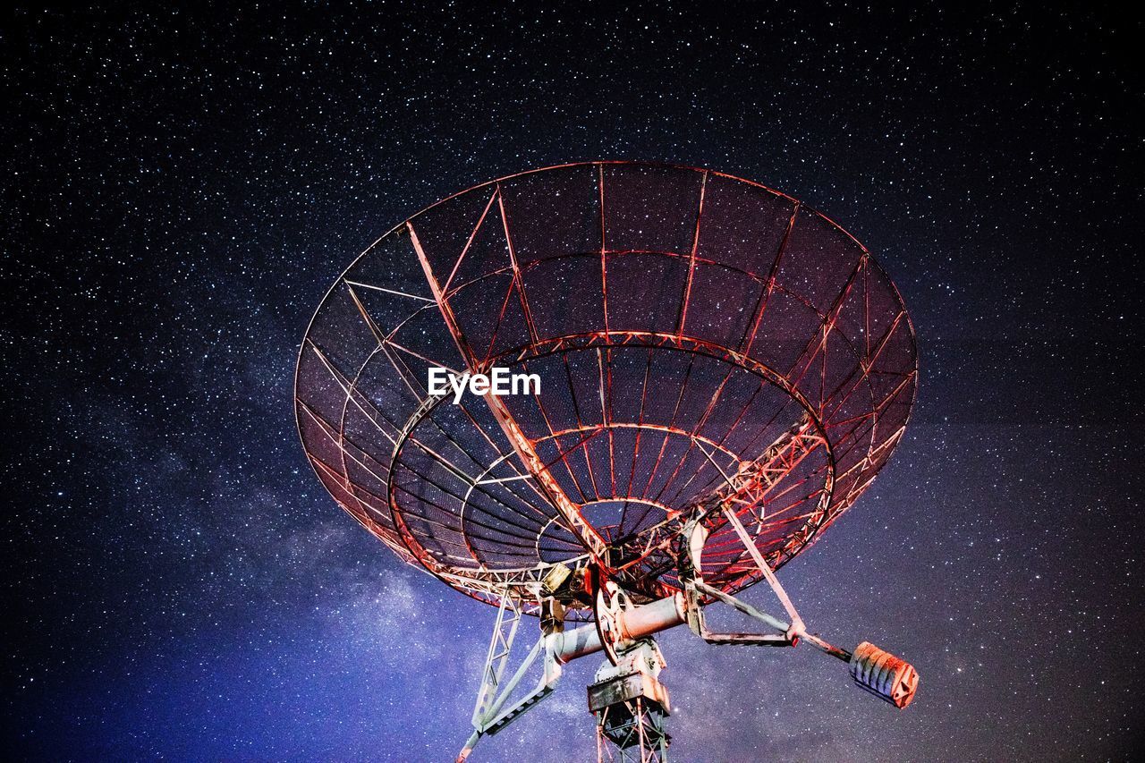 Low angle view of satellite against sky at night