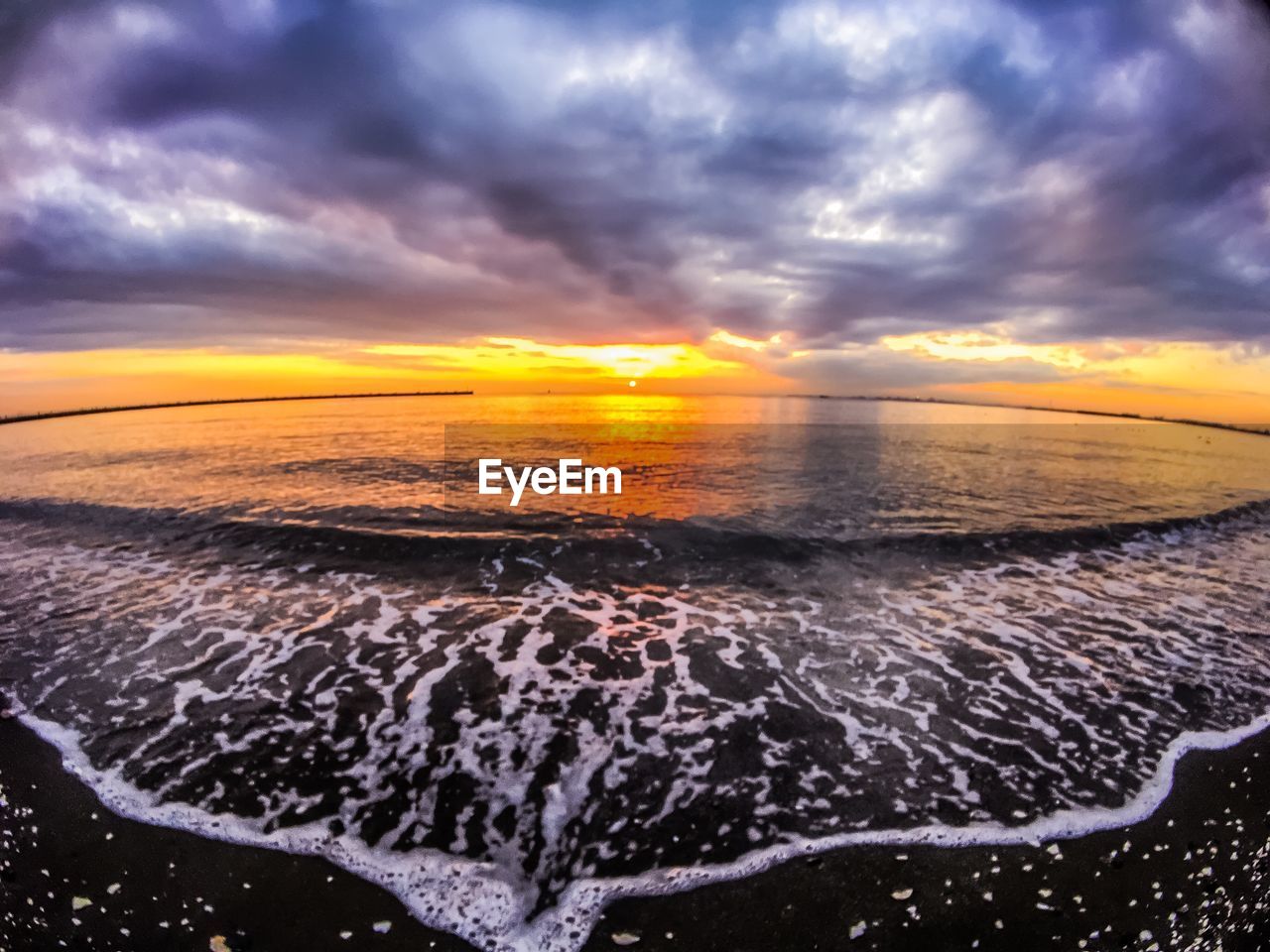 SCENIC VIEW OF SEA AGAINST ORANGE SKY