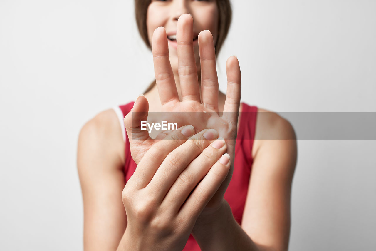 Cropped image of woman hand against white background