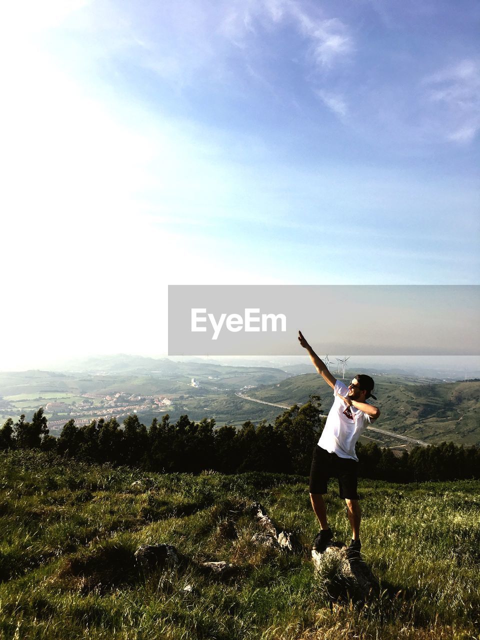 GIRL STANDING ON FIELD AGAINST SKY