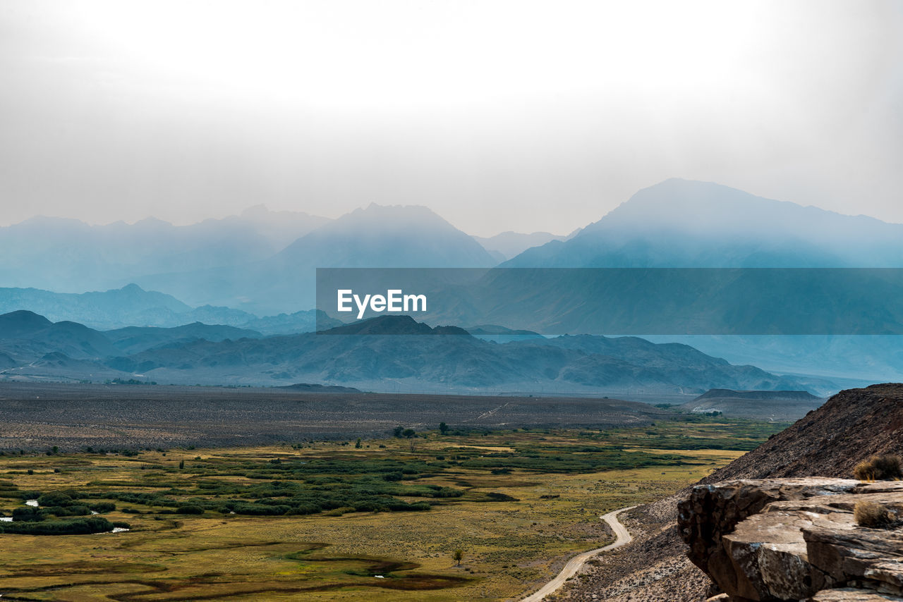 Cliff view of river valley and california forest fire smoke shrouded hills and mountains