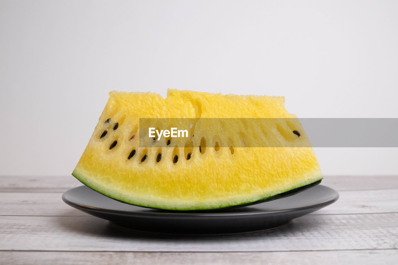 CLOSE-UP OF YELLOW FRUIT ON TABLE
