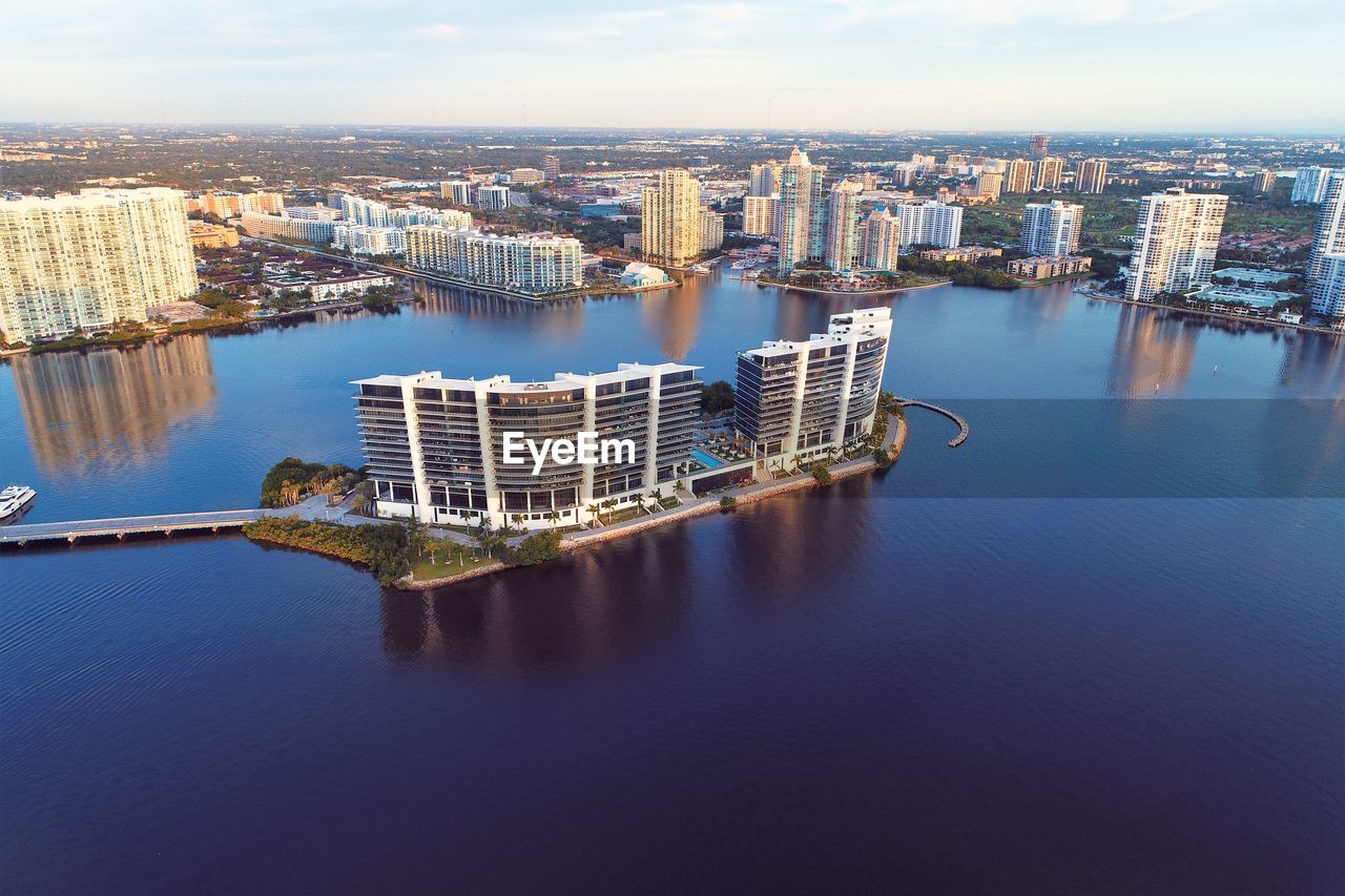 High angle view of river amidst buildings in city against sky