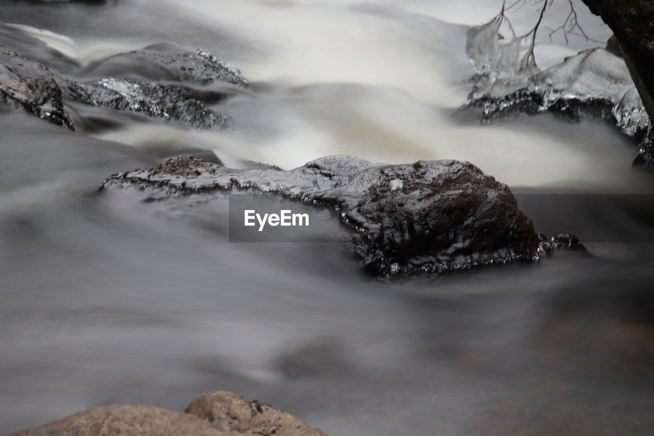 SCENIC VIEW OF SNOWCAPPED RIVER AGAINST MOUNTAINS