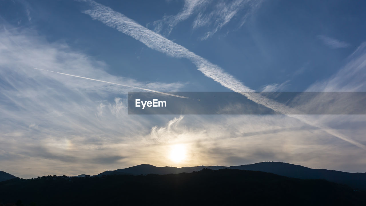 Low angle view of silhouette mountains against sky during sunset