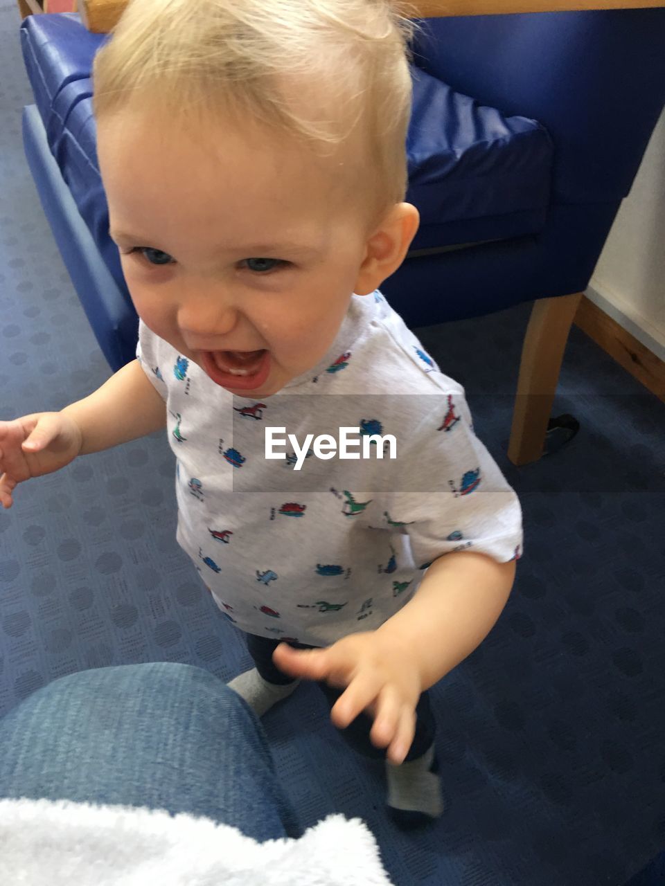 HIGH ANGLE VIEW OF CUTE BABY GIRL SITTING ON FLOOR