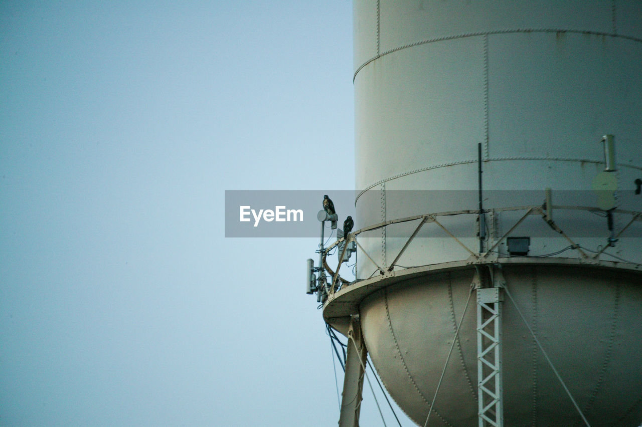 Low angle view of water tower against clear sky