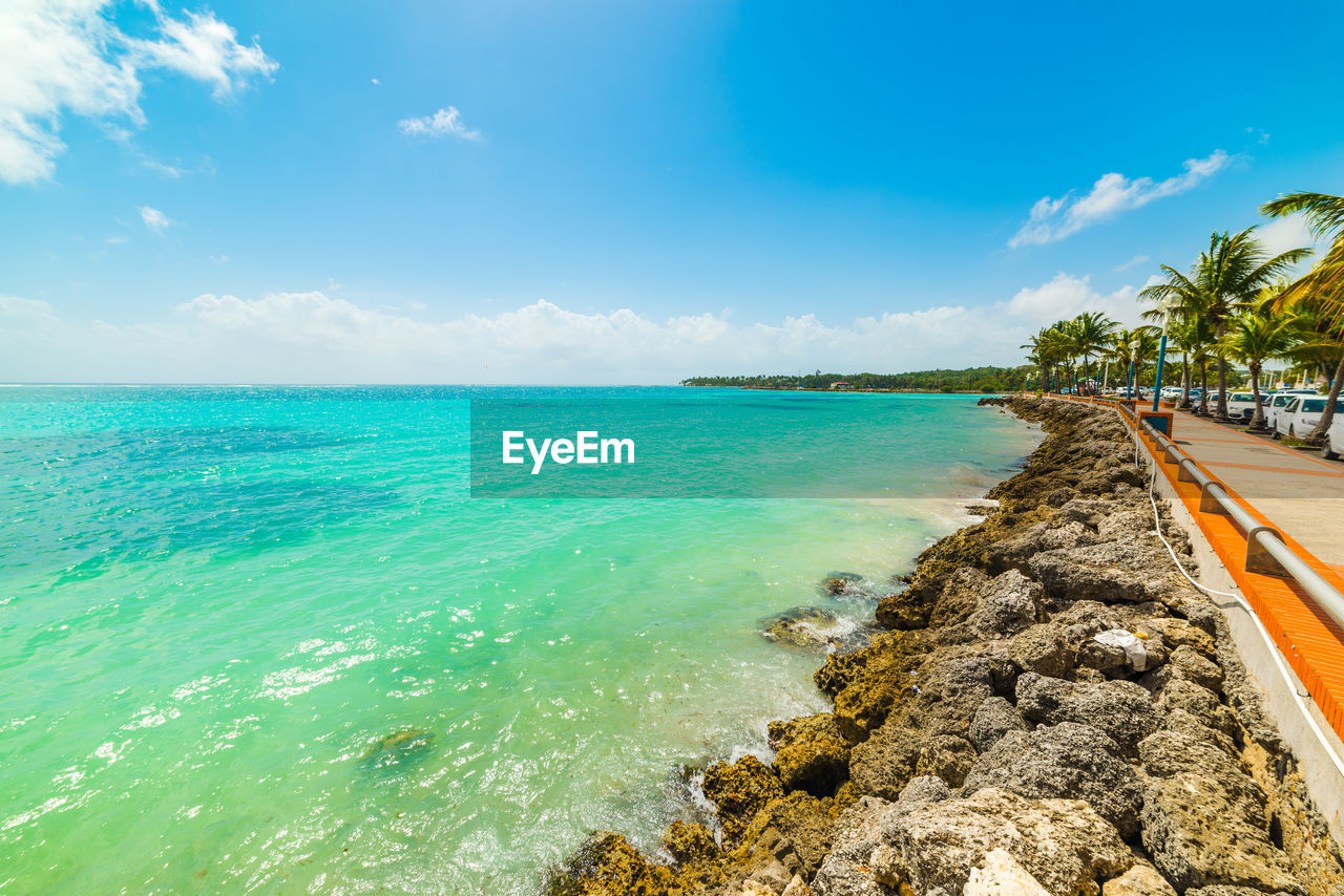 SCENIC VIEW OF BEACH AGAINST BLUE SKY