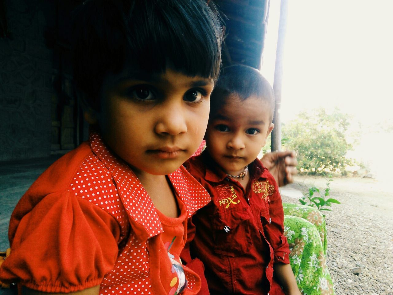 Close-up portrait of siblings outdoors