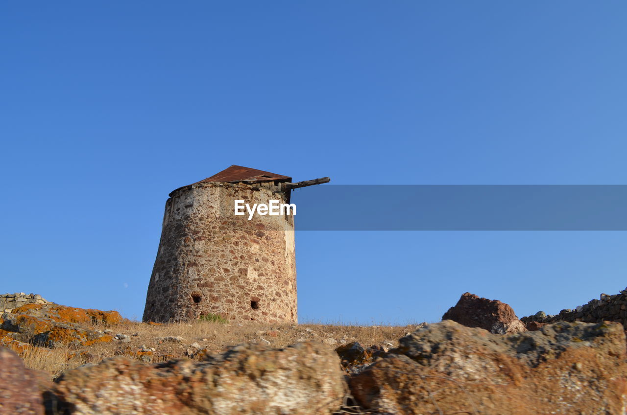 Low angle view of built structure against clear blue sky