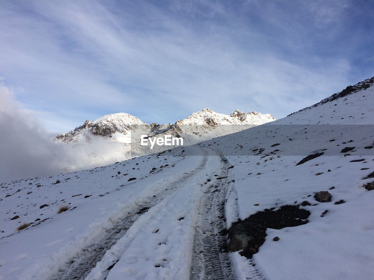 Scenic view of snow covered mountains against sky