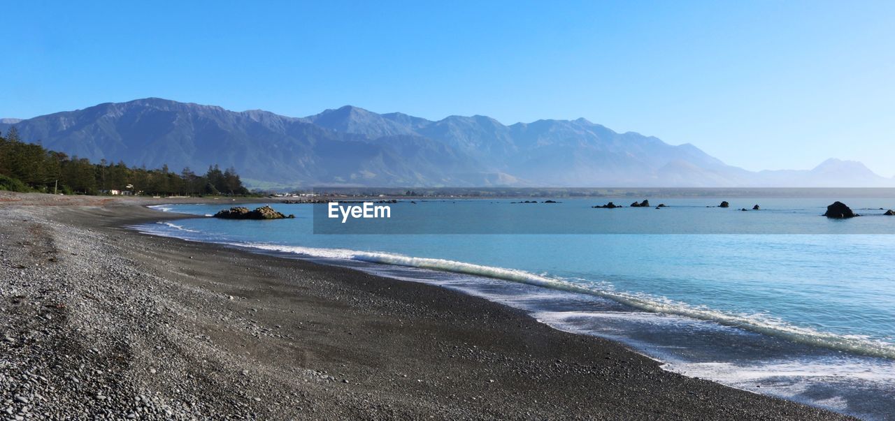 SCENIC VIEW OF BEACH AGAINST CLEAR BLUE SKY