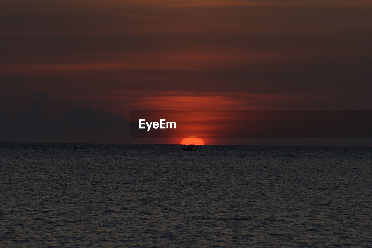 Scenic view of sea against romantic sky at sunset