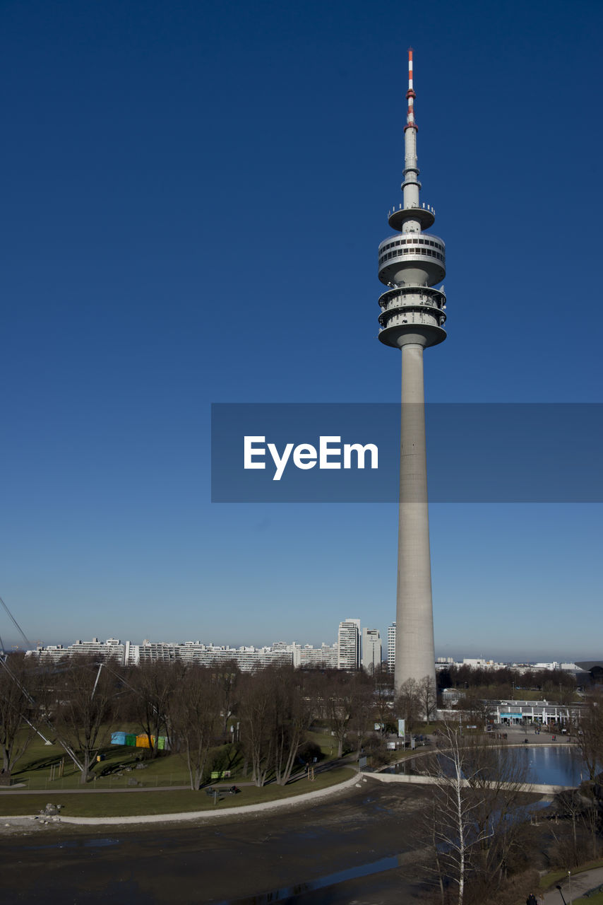 TOWER AMIDST BUILDINGS AGAINST CLEAR SKY