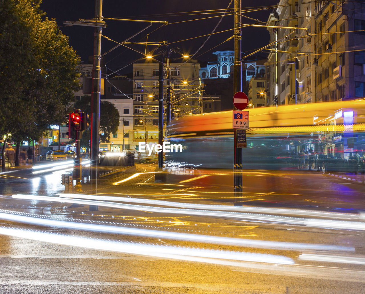 Blurred motion of cable car on road in city at night