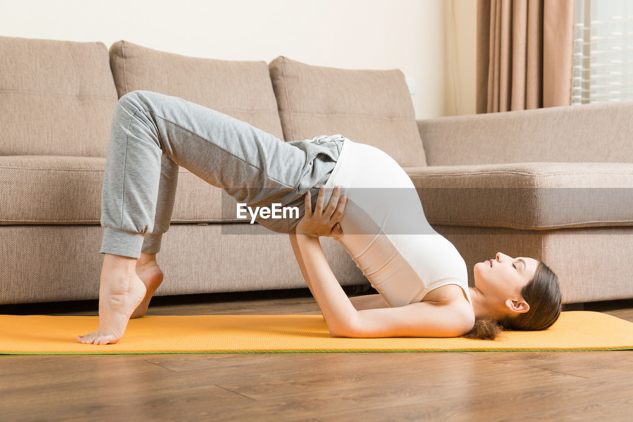 Portrait of young pregnant yoga model working at the home. pregnancy yoga and fitness concept 