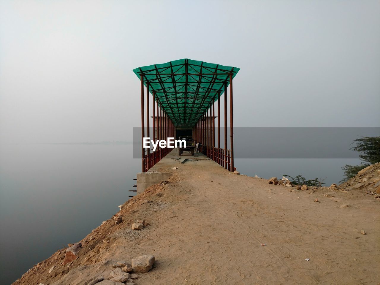 Pier against sea and sky during foggy weather